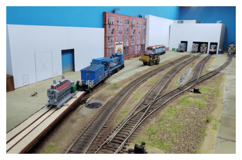 Image 7: Aaron's use of tall photo-realistic and large new structures add to the vertical scale and complement the small footprint of the layout